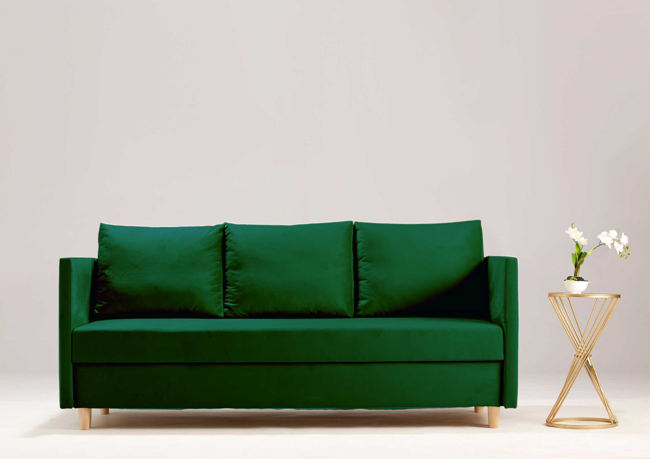 Mała sofa rozkładana w kolorze zielonym